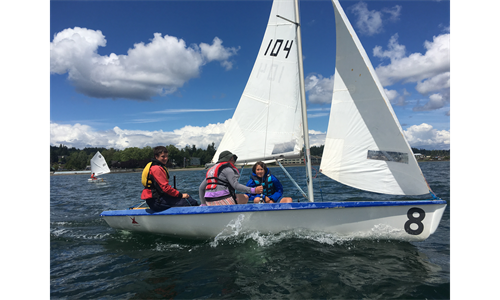 Teens sailing in V15 sailboat during summer camp